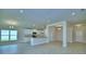 Open-concept living space with a kitchen featuring white cabinets and modern countertops at 4706 Grandview Glen Dr, Auburndale, FL 33823