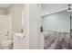 Well-lit bathroom features a white vanity, a toilet, and a tub with showerhead at 5225 Golden Gate Blvd, Polk City, FL 33868