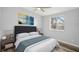 Cozy bedroom showcasing a comfortable bed, stylish decor, and ample natural light from the window at 5225 Golden Gate Blvd, Polk City, FL 33868