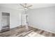 Spacious bedroom with a modern ceiling fan, wood-look flooring, and easy access to the en-suite bathroom at 5225 Golden Gate Blvd, Polk City, FL 33868