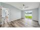 Bright bedroom featuring wood-look floors, a ceiling fan, and a glass door for natural light and easy access to outdoors at 5225 Golden Gate Blvd, Polk City, FL 33868