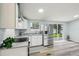 Bright kitchen with stainless steel appliances, granite countertops, and sliding glass doors to backyard at 5225 Golden Gate Blvd, Polk City, FL 33868