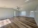 This home features hardwood floors and a ceiling fan at 5225 Golden Gate Blvd, Polk City, FL 33868