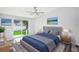 Comfortable main bedroom with a ceiling fan, neutral tones, a sliding glass door, and a stylish decor at 5225 Golden Gate Blvd, Polk City, FL 33868
