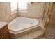 Luxurious bathroom featuring a corner soaking tub and shower at 108 Lake Region N Blvd, Winter Haven, FL 33881