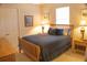 Cozy bedroom with a queen-size bed, soft lighting, and minimalist decor at 108 Lake Region N Blvd, Winter Haven, FL 33881