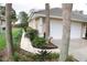 Landscaped exterior elevation of home with a two-car garage and brick walkway at 108 Lake Region N Blvd, Winter Haven, FL 33881