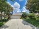 A well-maintained home featuring a tile roof, two-car garage, and meticulously manicured front lawn at 108 Lake Region N Blvd, Winter Haven, FL 33881