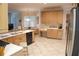 Open-concept kitchen featuring a breakfast bar, stainless steel appliances, and light wood cabinetry at 108 Lake Region N Blvd, Winter Haven, FL 33881