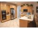 Spacious kitchen with wooden cabinets, white countertops, and stainless steel refrigerator at 108 Lake Region N Blvd, Winter Haven, FL 33881