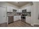 Modern kitchen with white cabinets, granite counters, and stainless steel appliances at 506 N Wales Dr, Lake Wales, FL 33853