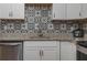 Modern kitchen with white cabinets, granite countertops, and stylish backsplash at 506 N Wales Dr, Lake Wales, FL 33853