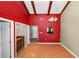 Dining room with red accent wall and wood beam ceiling at 5225 Imperial Lakes Blvd # 22, Mulberry, FL 33860