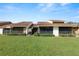 Two-story condo with screened patio, grassy yard, and grill at 5225 Imperial Lakes Blvd # 22, Mulberry, FL 33860
