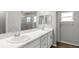 Elegant bathroom with double sinks, quartz countertops, and a glass-enclosed shower at 572 Sw 77Th Cir, Ocala, FL 34480
