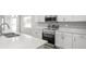 Modern kitchen features quartz countertops and stainless steel appliances at 572 Sw 77Th Cir, Ocala, FL 34480