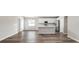 Open-concept living area features wood flooring and integrates with a modern kitchen at 572 Sw 77Th Cir, Ocala, FL 34480