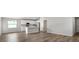 Open-concept living area features wood flooring and integrates with a modern kitchen at 572 Sw 77Th Cir, Ocala, FL 34480