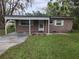 Charming single-story home with a carport, tidy landscaping, and green lawn at 3203 Decatur Ave, Lakeland, FL 33805