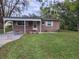 View of the front of a house with a carport, garden, and well-maintained lawn at 3203 Decatur Ave, Lakeland, FL 33805
