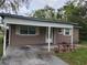 Inviting home featuring a carport, well-maintained lawn, and manicured front garden at 3203 Decatur Ave, Lakeland, FL 33805