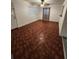 Cozy living area featuring unique patterned floors, a ceiling fan, and ample natural light at 3203 Decatur Ave, Lakeland, FL 33805