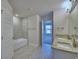 Bathroom with double sink, soaking tub, tiled floors, and a bright, open feel at 5126 Villa Crest Way, Auburndale, FL 33823