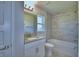 Bright bathroom showcasing a bathtub, gray tile accents, and a vanity with a granite countertop at 5126 Villa Crest Way, Auburndale, FL 33823