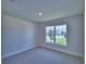 Bright bedroom features neutral carpeting and a large window offering natural light and views at 5126 Villa Crest Way, Auburndale, FL 33823