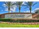 A landscaped entrance to Lake Juliana Estates with palm trees and a decorative stone sign at 5126 Villa Crest Way, Auburndale, FL 33823