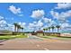 Lake Juliana Estates entrance featuring palm trees, brick signage and well-manicured landscaping on a sunny day at 5126 Villa Crest Way, Auburndale, FL 33823
