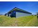 Single-story home with blue-gray paint, dark roof tiles, and well-maintained lawn at 5126 Villa Crest Way, Auburndale, FL 33823
