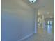Bright hallway with neutral walls and tile flooring, leading to an open floor plan at 5126 Villa Crest Way, Auburndale, FL 33823