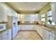 Bright kitchen featuring white cabinetry, granite countertops, and modern appliances at 5126 Villa Crest Way, Auburndale, FL 33823