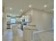 Well-lit kitchen featuring white cabinets, granite countertops, stainless steel appliances, and tile flooring at 5126 Villa Crest Way, Auburndale, FL 33823