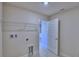 Functional laundry room with overhead shelving and connections for a washer and dryer at 5126 Villa Crest Way, Auburndale, FL 33823