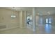 Open-concept living space with tile flooring, bright lighting, and a view of the modern kitchen at 5126 Villa Crest Way, Auburndale, FL 33823