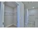 Walk-in closet with shelving system for optimal storage, adjacent to the hall and bathroom at 5126 Villa Crest Way, Auburndale, FL 33823
