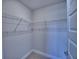 Walk-in closet with a single shelf and bar for storage and organization of personal items at 5126 Villa Crest Way, Auburndale, FL 33823