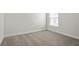 Cozy bedroom featuring soft carpeting and a bright window with blinds at 1365 Melrose St, Lake Alfred, FL 33850