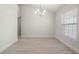 Dining area features wood floors and a modern chandelier at 1365 Melrose St, Lake Alfred, FL 33850