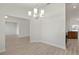 Dining room with modern chandelier that opens to kitchen at 1365 Melrose St, Lake Alfred, FL 33850