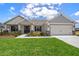 Charming single-Gathering home featuring a well-manicured lawn and a two-car garage at 1365 Melrose St, Lake Alfred, FL 33850