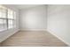 Spacious living area features wood flooring and natural light from the large window at 1365 Melrose St, Lake Alfred, FL 33850