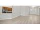 Bright living room featuring wood-look floors that lead to kitchen and front door at 1365 Melrose St, Lake Alfred, FL 33850