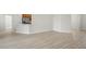 Open living room featuring stylish flooring that leads to kitchen and doorway at 1365 Melrose St, Lake Alfred, FL 33850