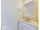 Bathroom vanity with a single sink, white cabinet, and a framed mirror and towel ring at 1836 N Crystal Lake Dr # 46, Lakeland, FL 33801