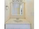Bathroom vanity with a single sink, white cabinet, and a framed mirror at 1836 N Crystal Lake Dr # 46, Lakeland, FL 33801