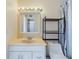 Well-lit bathroom featuring a vanity with a large mirror and a convenient storage shelf at 1836 N Crystal Lake Dr # 46, Lakeland, FL 33801