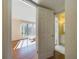 View of a bedroom with a large window and wood floors, as seen from the doorway, with the bathroom across the hall at 1836 N Crystal Lake Dr # 46, Lakeland, FL 33801